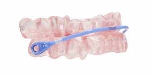 Pink dental appliance with a blue adjustable strap for sleep therapy or jaw alignment.